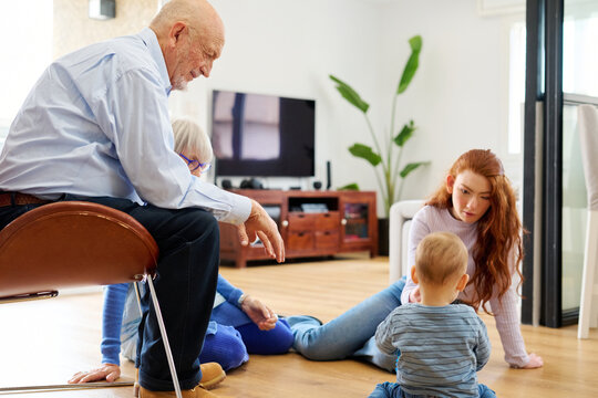 Family playing with baby at home.