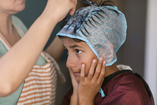 Mother Pulling Out Strands Of Her Son's Hair