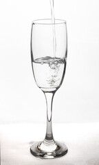 close up of pouring pure fresh drinking water on white background isolated