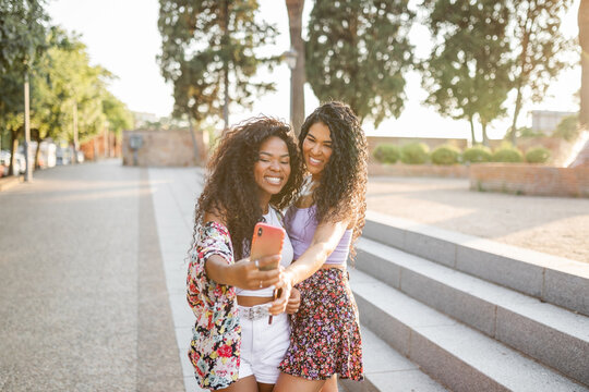 multiracial young women with mobile phone in the city