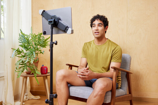 Hispanic trainer shooting video at home