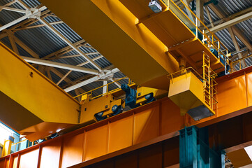 Service cabin on beam of yellow equipment at plant