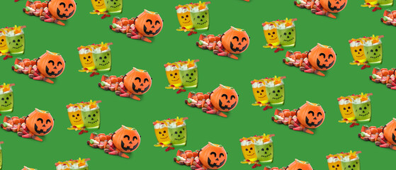 Tasty desserts for Halloween party on green background