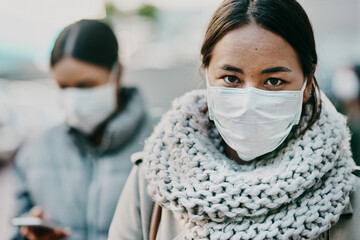 Sick young covid patient, wearing medical face mask to stop the spread of virus pandemic. Woman standing outside in public crowd during viral coronavirus outbreak. Female taking healthcare precaution