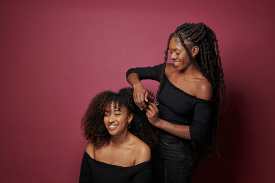 woman styling afro hair with comb