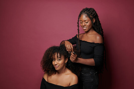 woman styling afro hair 