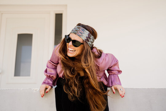 Happy screaming woman sitting on porch