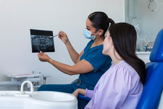 Dentist showing x-rays to a patient in a dental clinic