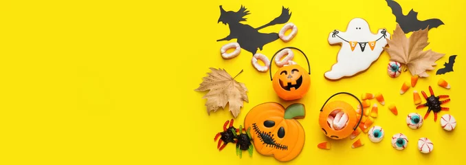 Fotobehang Composition with tasty Halloween treats on yellow background with space for text, top view © Pixel-Shot