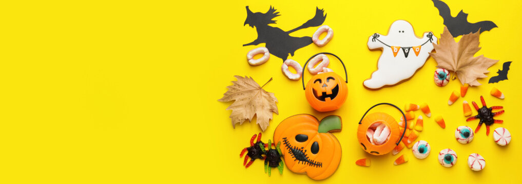 Composition with tasty Halloween treats on yellow background with space for text, top view