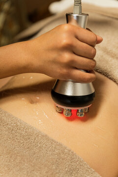 woman receiving a cavitation massage therapy on her belly