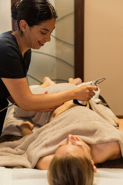 Therapist smiling giving a cavitation massage