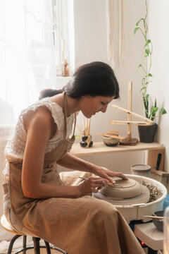 Female Artisan Making A Bowl On The Pottery Wheel