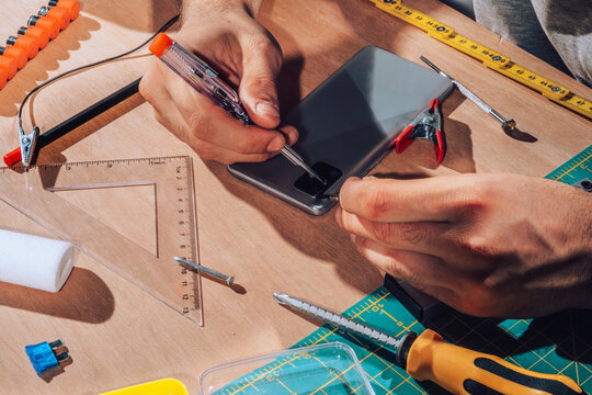Technician repairing  device with his tools.