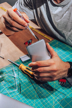 Technician repairing  device with his tools.