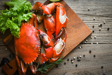 Fresh crab on wooden plate, boiled or steamed crab red in the restaurant, claw crab cooking food...