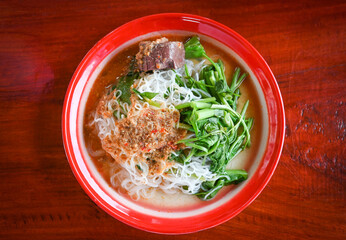 Thai rice noodle or rice vermicelli noodle and curry soup sauce on plate with vegetable yardlong , Thai style food delicious