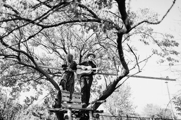 portrait of a young couple playing guitar together