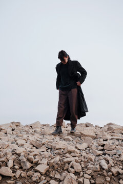 Woman Standing On A Pile Of Stones