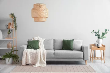 Foto op Plexiglas Grey sofa, table and shelving unit with houseplants near light wall © Pixel-Shot