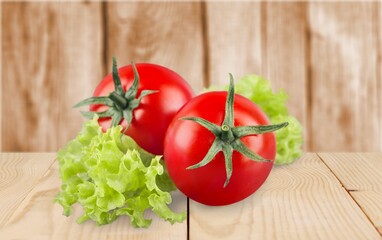 Tasty ripe fresh red tomatoes on the desk