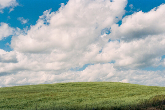 Landscape with a green hill against cloudy sky