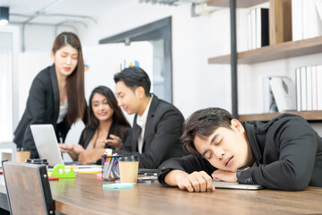 Businessman knock down on desk. overload working or deteriorating health or failure business down trend. Sleeping on the Desk at Work.