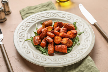 Plate of tasty baked carrots, closeup
