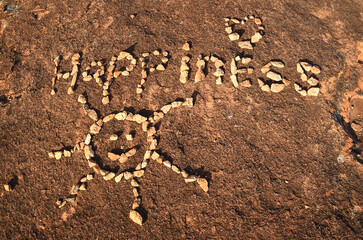 Happiness said in rocks on a rock.