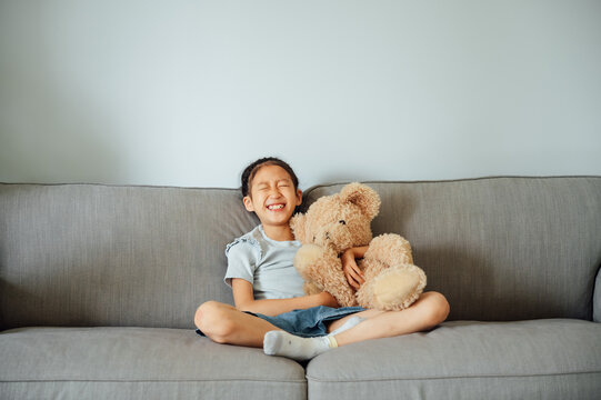 Portrait of cute girl hugging her toy teddy