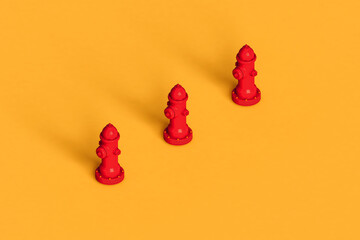 three red hydrants on yellow