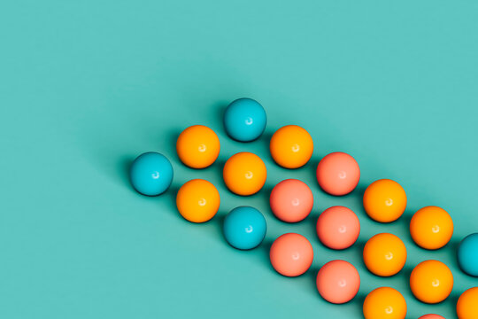 rows of colorful spheres on blue background. 3d render