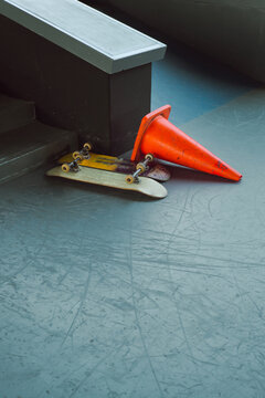 Skateboards near plastic traffic cone