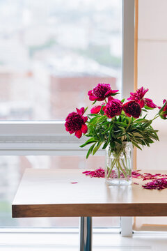 Falling flower bouquet in empty apartment.