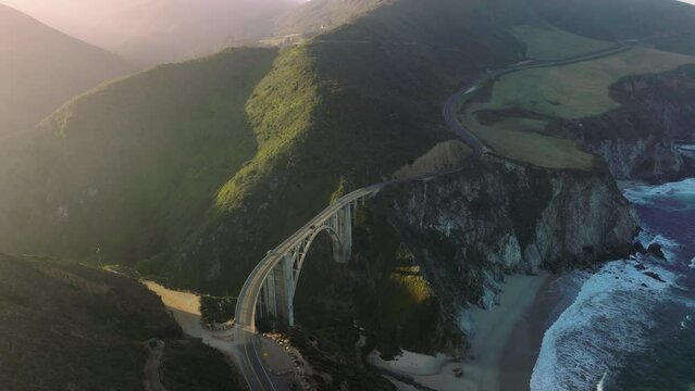 Drone footage over scenic drive right up to the beach. Exciting viewing along byway route, over unforgettable Bixby Bridge in Big Sur, California, USA. High quality 4k footage