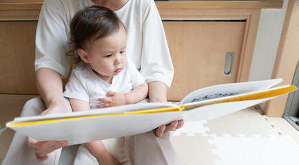 A mother reads a picture book for her child