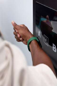 Man using smartwatch to pay at recharging station 