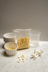 Nose wax kit. Wax set for nose hair removal. Dry wax beads, paper cups with applicator sticks for nose depilation on the white background 