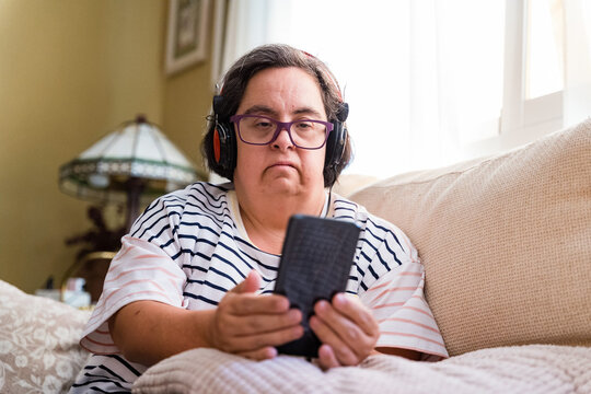 woman with down syndrome looking at smartphone