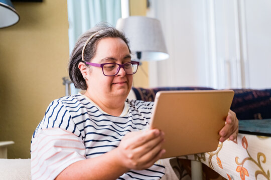 woman with down syndrome using a tablet
