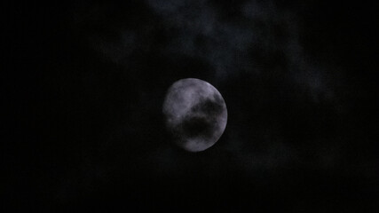 Obraz na płótnie Canvas The Waxing Gibbous Moon in the cloudy night sky.
