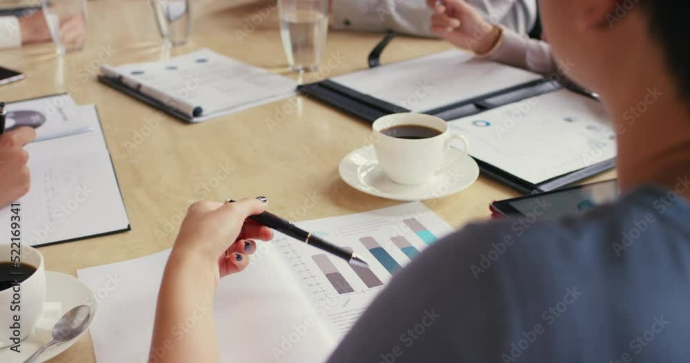 Poster closeup of a young woman reading finance data in a business meeting with colleagues, discussing plan