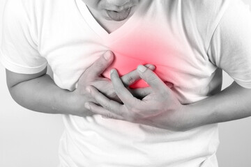 Man is sick and in pain and uses his hands to squeeze his chest He had chest pain caused by an acute heart attack. medical and health concepts