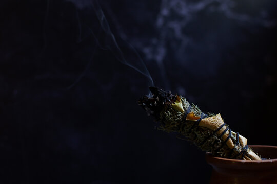 Detail of a wooden mortar kitchen next to a herbal wand stick