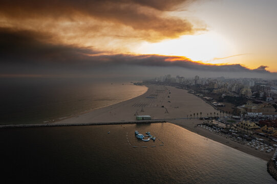 Aerial landscape of coastal town and calm bay at sunset