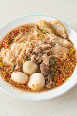 noodles with pork and meatballs in spicy soup