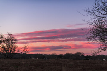 deep pink sunset sky over suburban rural landscape in Texas