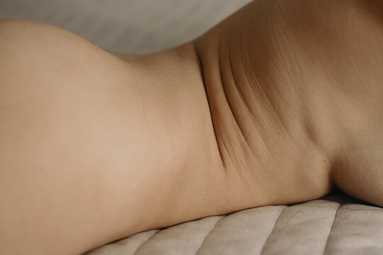Close up vertical photo of naked woman's skin Folds 
