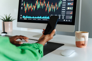Crop woman using smartphone in office