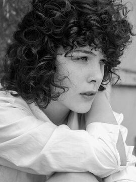 Close portrait of a young curly girl model